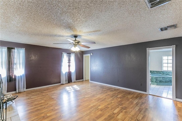 180 Fcr 797, Donie, TX 75838 - spare room with ceiling fan, plenty of natural light, wood finished floors, a textured ceiling, and baseboards