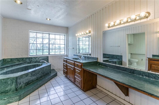 180 Fcr 797, Donie, TX 75838 - full bath with toilet, a bath, tile patterned floors, two vanities, and a textured ceiling