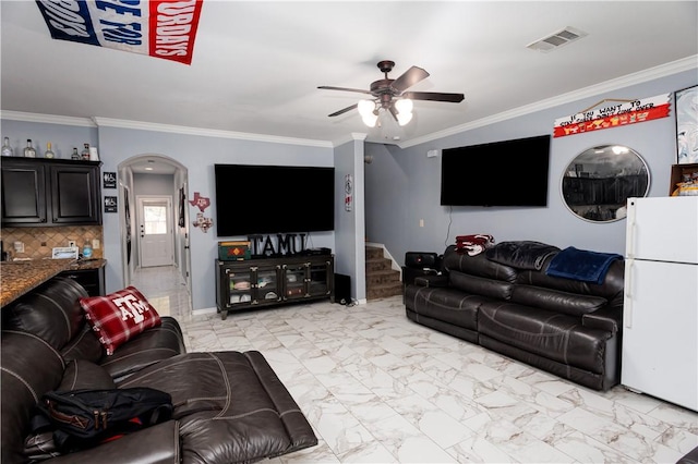 living room with ceiling fan and ornamental molding