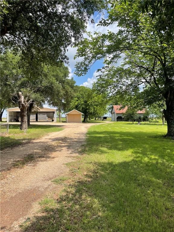 6268 Fm 2269, Cameron, TX 76518 - view of front facade with driveway, a front lawn, and an outbuilding