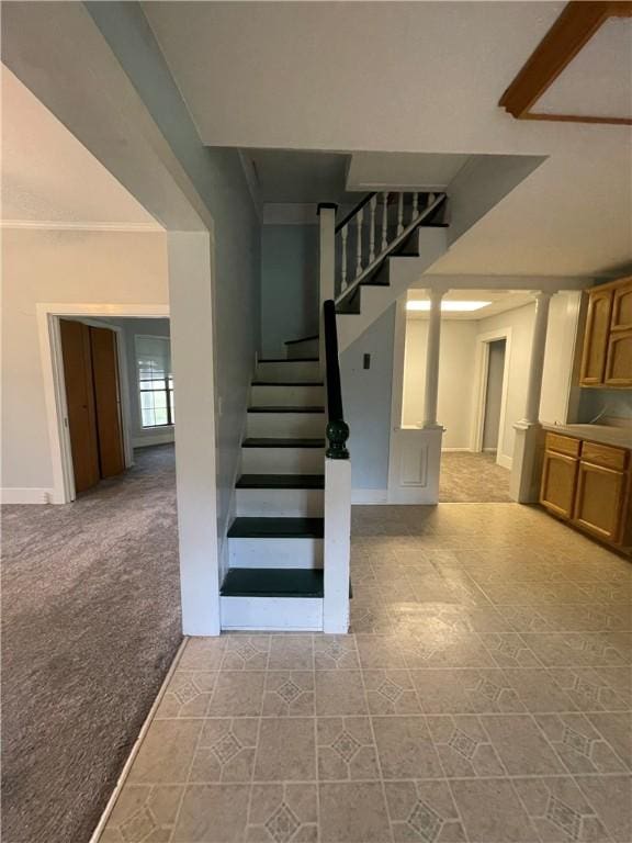 6268 Fm 2269, Cameron, TX 76518 - stairway with baseboards, carpet floors, tile patterned flooring, and crown molding