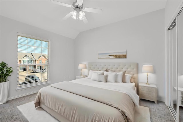 bedroom featuring ceiling fan, a closet, lofted ceiling, and carpet floors