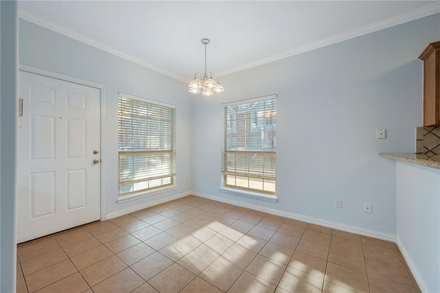 unfurnished dining area with ornamental molding, a notable chandelier, and light tile patterned floors