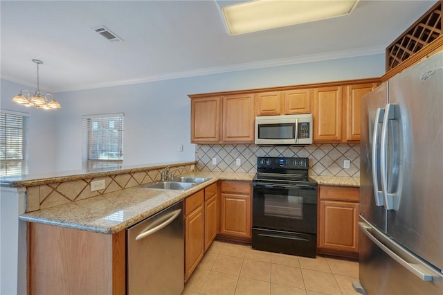 kitchen with appliances with stainless steel finishes, kitchen peninsula, a notable chandelier, ornamental molding, and sink