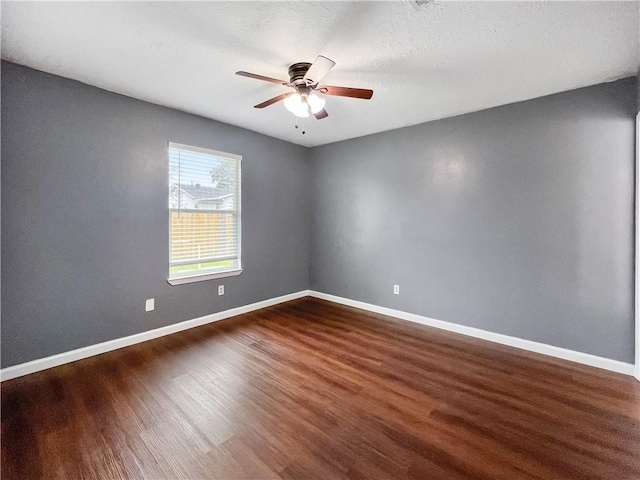 spare room with ceiling fan, dark hardwood / wood-style flooring, and a textured ceiling