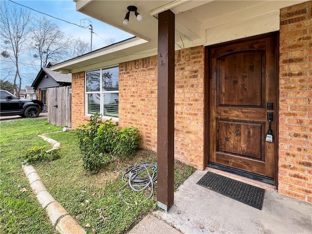 entrance to property featuring a yard