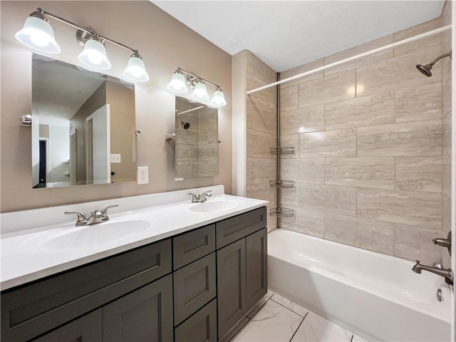 bathroom featuring vanity and tiled shower / bath combo