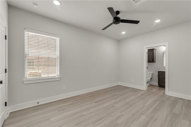 unfurnished bedroom featuring ensuite bathroom, ceiling fan, and light hardwood / wood-style flooring