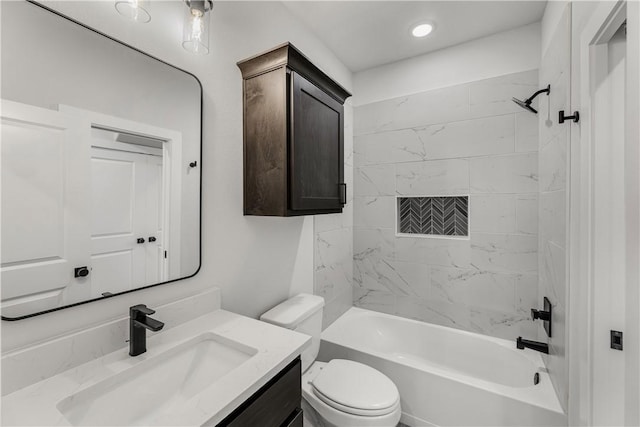 full bathroom with tiled shower / bath, vanity, and toilet