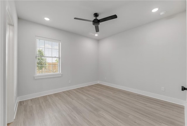 empty room with ceiling fan and light wood-type flooring