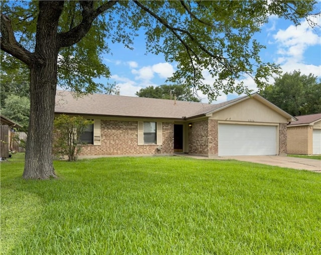 3234 Red Robin Loop, Bryan, TX 77802 - ranch-style house with a garage, a front yard, driveway, and brick siding