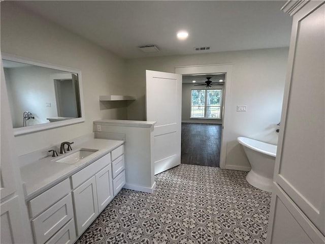 bathroom featuring a bathtub, ceiling fan, hardwood / wood-style floors, and vanity