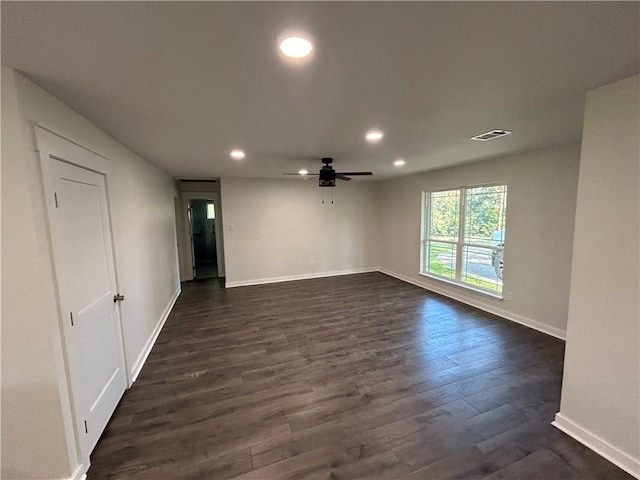 empty room with ceiling fan and dark hardwood / wood-style flooring