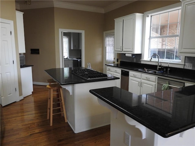 kitchen featuring a kitchen breakfast bar, sink, and white cabinets