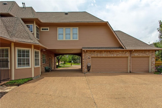 view of front facade with a garage and a carport