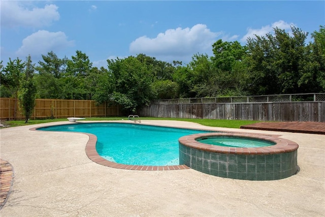 view of pool with an in ground hot tub, a deck, a diving board, and a patio area