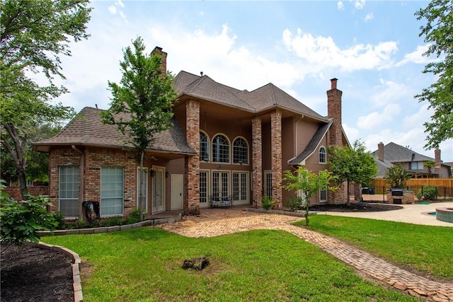 view of front of home featuring a patio area, french doors, and a front lawn