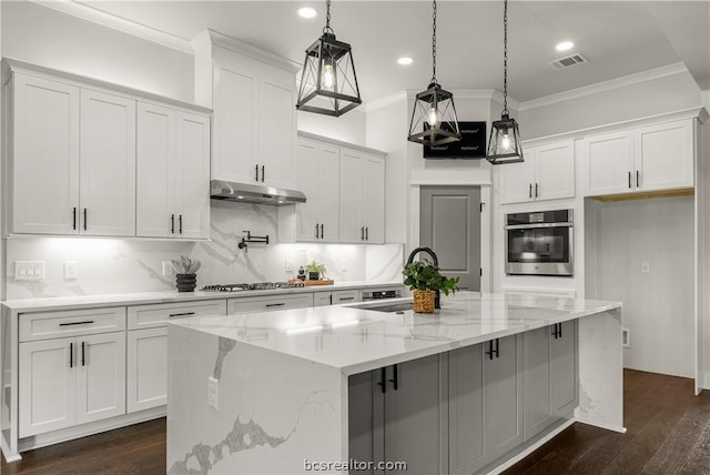 2023 Lola Ln, Bryan, TX 77807 - kitchen featuring stainless steel oven, under cabinet range hood, ornamental molding, gas cooktop, and white cabinets