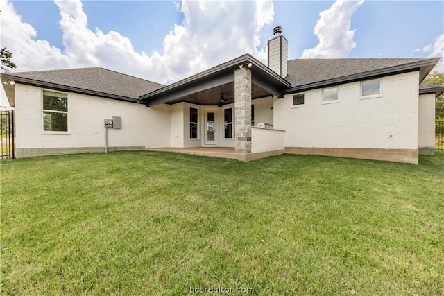 rear view of house with a patio area, ceiling fan, and a yard