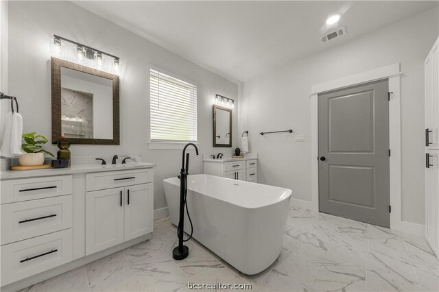 2023 Lola Ln, Bryan, TX 77807 - full bath with marble finish floors, vanity, and a freestanding bath