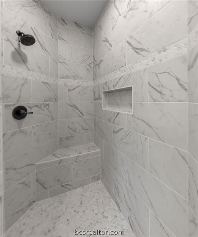 bathroom with tiled shower