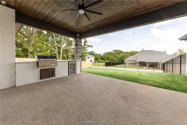 view of patio with wine cooler, grilling area, an outdoor kitchen, and ceiling fan