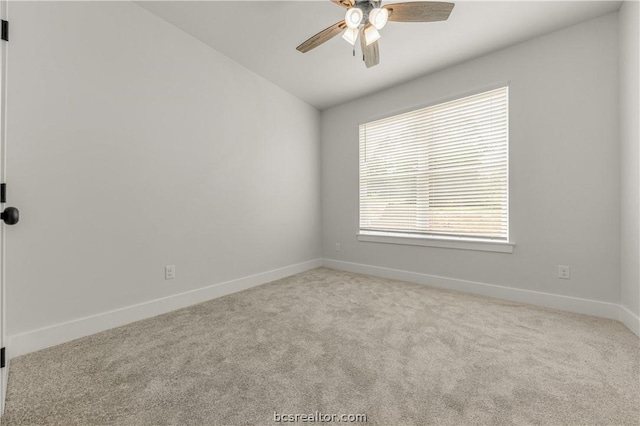 carpeted empty room with ceiling fan and lofted ceiling