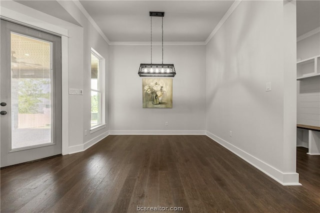 2023 Lola Ln, Bryan, TX 77807 - unfurnished dining area featuring dark wood finished floors, ornamental molding, and a chandelier