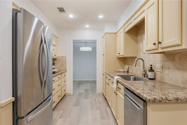 1818 Laura Ln, College Station, TX 77840 - kitchen featuring stainless steel appliances, a sink, tasteful backsplash, light wood-type flooring, and baseboards