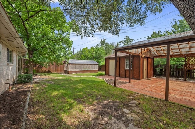 1818 Laura Ln, College Station, TX 77840 - view of yard featuring an exterior structure, an outdoor structure, and a patio