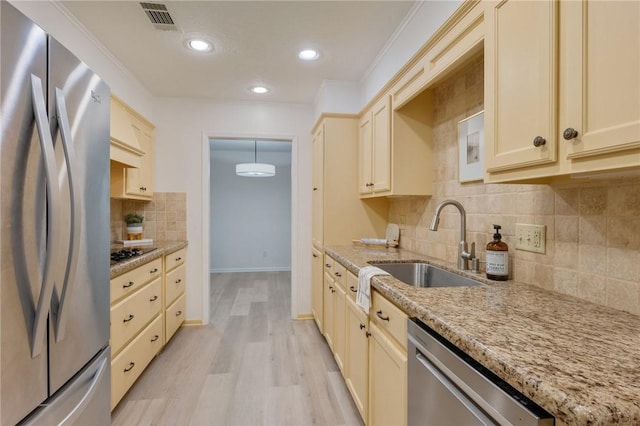 1818 Laura Ln, College Station, TX 77840 - kitchen with appliances with stainless steel finishes, a sink, light wood finished floors, tasteful backsplash, and light stone countertops