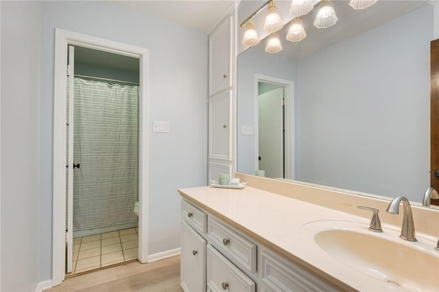 1818 Laura Ln, College Station, TX 77840 - full bath with vanity, a chandelier, toilet, and wood finished floors