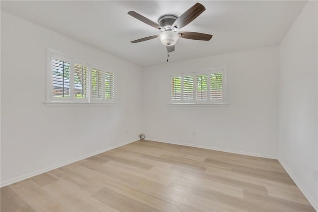 1818 Laura Ln, College Station, TX 77840 - empty room with light wood-type flooring, healthy amount of natural light, a ceiling fan, and baseboards