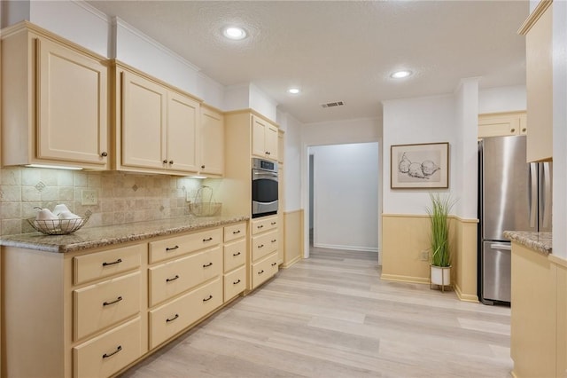 1818 Laura Ln, College Station, TX 77840 - kitchen with stainless steel appliances, light wood finished floors, decorative backsplash, light stone countertops, and recessed lighting