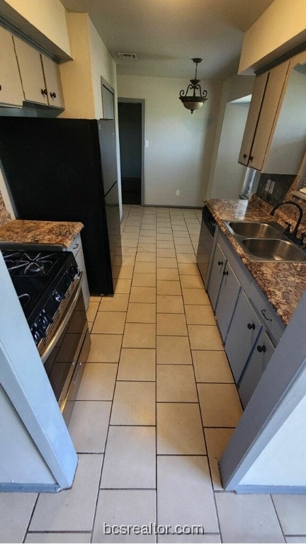 kitchen featuring gray cabinets, sink, light tile patterned floors, and stainless steel appliances