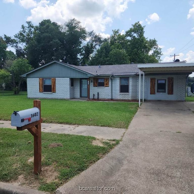 ranch-style home with a carport and a front lawn