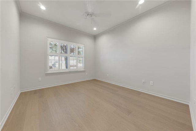 empty room with recessed lighting, baseboards, light wood-style flooring, and crown molding