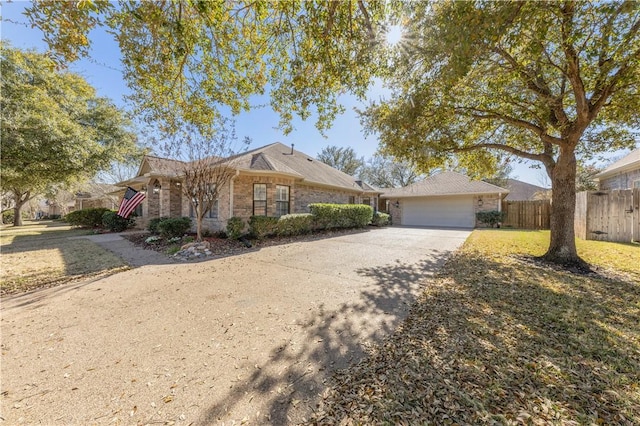 ranch-style house featuring a front lawn, fence, concrete driveway, an attached garage, and brick siding