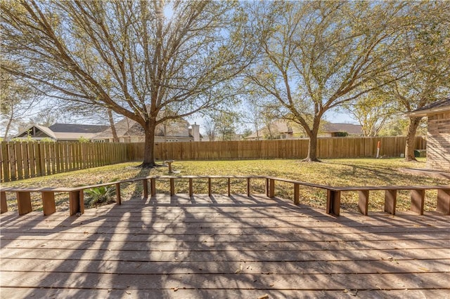 deck with a yard and a fenced backyard