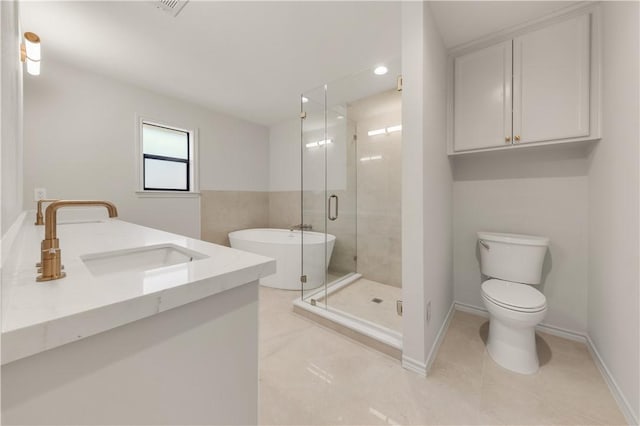 full bathroom featuring toilet, a stall shower, tile patterned flooring, baseboards, and a freestanding bath