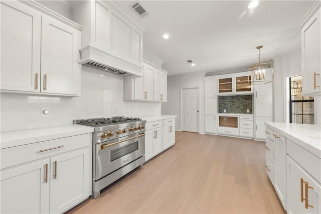 kitchen featuring light wood-style floors, high end stainless steel range, and white cabinets