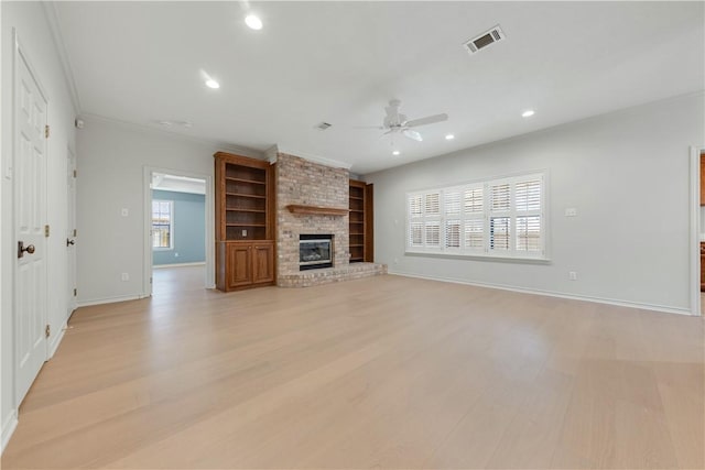 unfurnished living room with visible vents, light wood-style flooring, recessed lighting, a brick fireplace, and ceiling fan