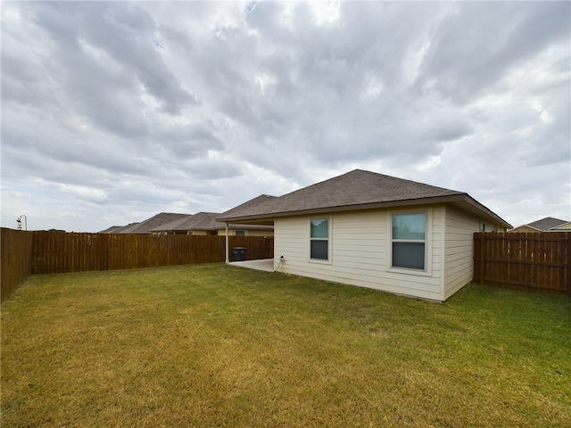 rear view of house with a yard