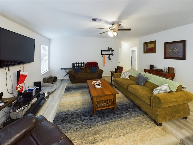 living room featuring ceiling fan and hardwood / wood-style floors