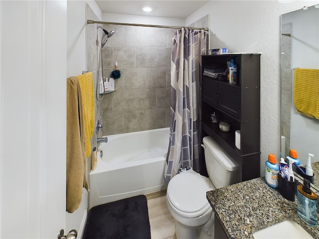 full bathroom with vanity, shower / tub combo, and toilet