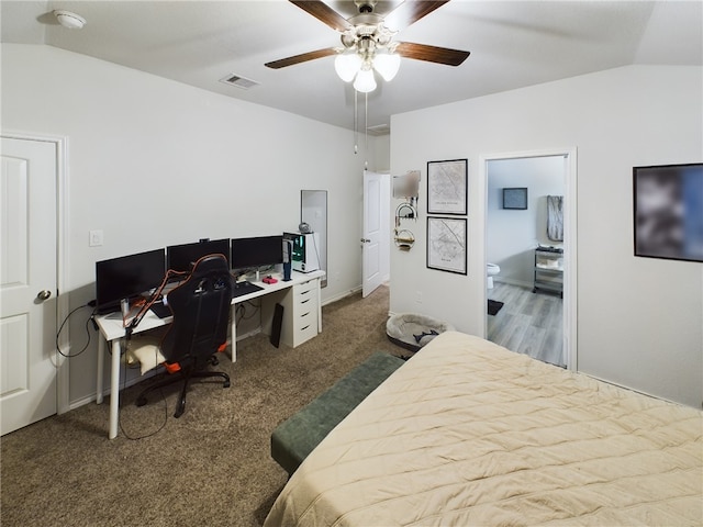 bedroom featuring ceiling fan, carpet, ensuite bathroom, and vaulted ceiling