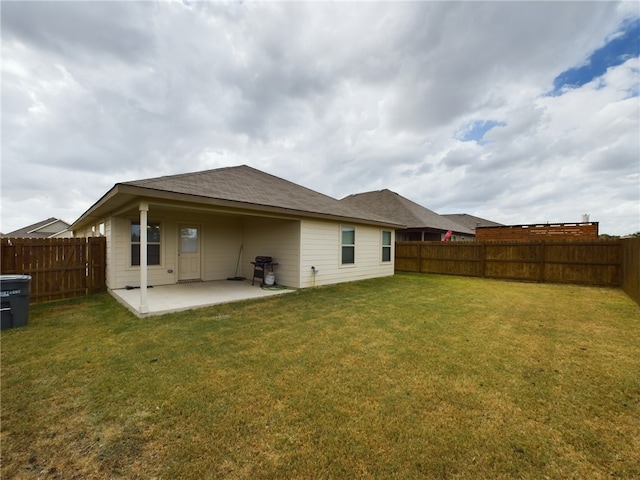 back of property featuring a lawn and a patio