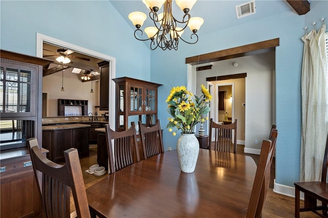 dining area with visible vents, baseboards, dark wood-style flooring, and ceiling fan with notable chandelier