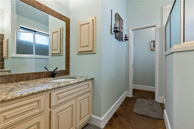 bathroom featuring tile patterned floors, vanity, and baseboards