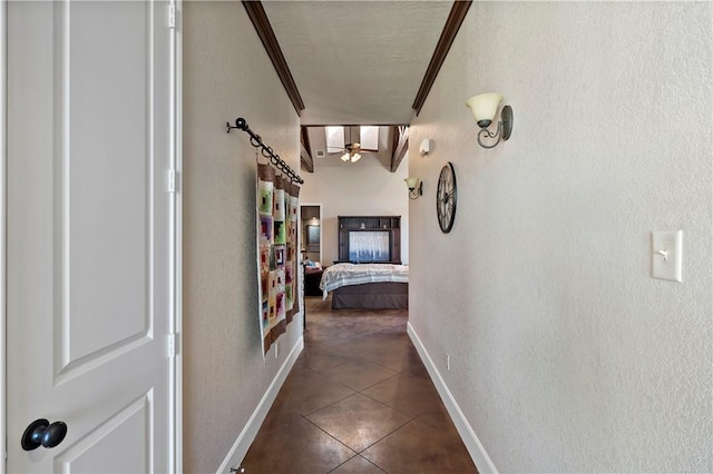 hallway featuring tile patterned flooring and baseboards